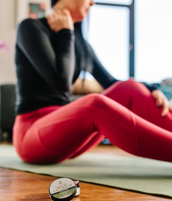 A person with a healthy posture stretching gently in a bright, modern space.